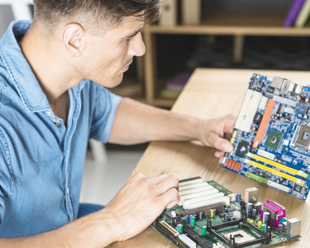 close-up-of-it-man-learning-the-motherboard-circuit